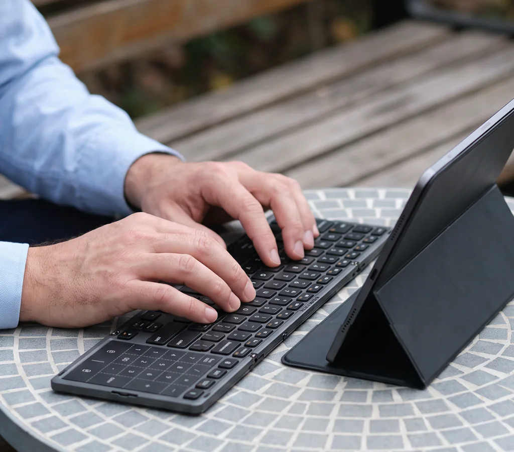 Hands using AF01 with a tablet at a temporary outdoor workspace